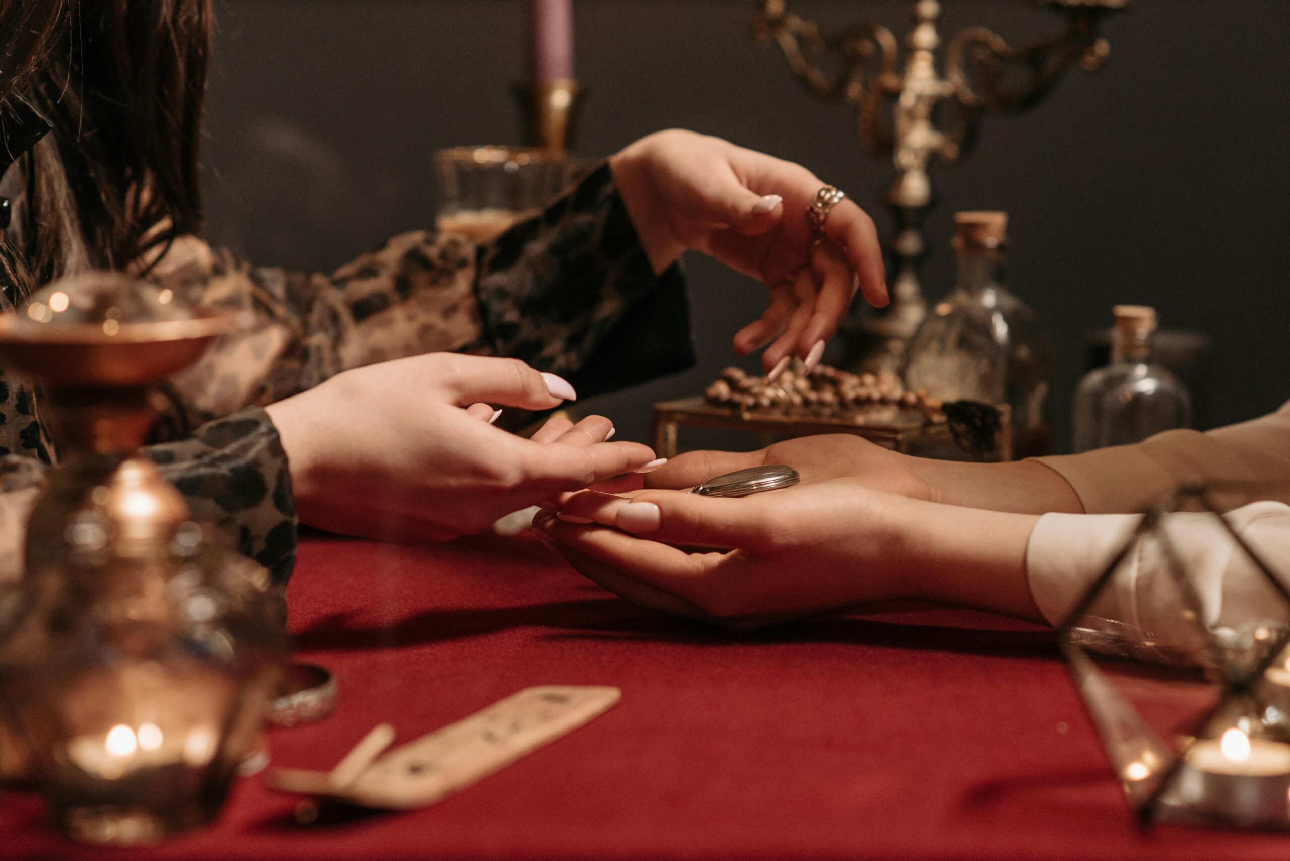 pexels-photo-7221686-7221686 A fortune teller delicately reading a client's palm in a mystic setting with enchanting ambiance.